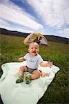 Baby Sitting on a Blanket Outdoors, Father in a Tent in the Background, Steamboat Springs, Routt County, Colorado, USA