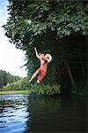 Teenage Boy Jumping Into Lake, Near Portland, Oregon, USA