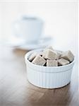 Bowl of Raw Sugar Cubes, Cup of Coffee in the Background