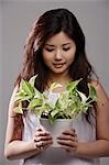 Chinese woman holding green plant