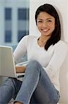 Young Asian woman working on laptop
