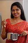 Indian woman wearing sari while preparing food.