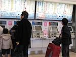 People buying ticket at the ticket machines, Shinagawa station, Tokyo, Japan