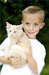 Boy posing with cat