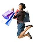 Woman leaping with gift bags