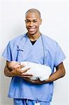 Male Doctor holding newborn baby
