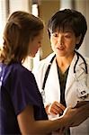 Female doctor talking to nurse
