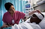 Nurse talking with boy in hospital bed