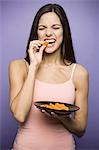 Woman eating carrot sticks