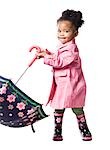 Studio portrait of baby girl (18-23 months) holding umbrella