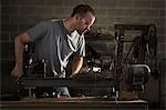 USA, Utah, Orem, man using machine in workshop