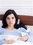 Orem, Utah, USA, young ill woman lying down in bed