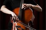 Close-up of young woman playing cello