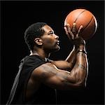 Studio shot of basketball player holding ball