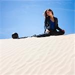USA, Utah, Little Sahara, businesswoman wearing ball and chain in desert