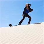 USA, Utah, Little Sahara, businesswoman wearing ball and chain in desert