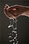 Young woman's hands cupping water