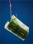 One hundred Euros banknote on hook, against blue background