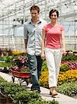 USA, Utah, Salem, mid adult couple choosing plants in greenhouse
