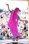 USA, Utah, Spanish Fork, rear view of mid adult dancer in traditional clothing performing on stage