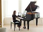USA, Utah, Alpine, girl (8-9) practicing piano