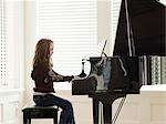 USA, Utah, Alpine, girl (8-9) practicing piano, side view