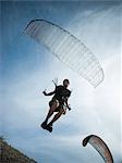 USA, Utah, Lehi, mature man taking off with paraglide, low angle view