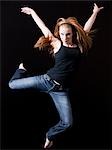 Young woman jumping, studio shot