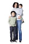 Studio portrait of mother with two sons (18-23 months, 8-9 years)