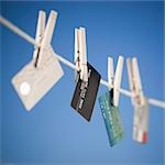 Various credit cards hanging on clothes line