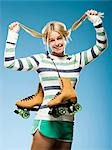 Studio portrait of young woman with roller skates