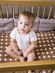 USA, Utah, Provo, Portrait of baby boy (18-23 months) sitting in crib