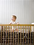 USA, Utah, Provo, Baby boy (18-23 months) standing in crib