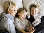 USA, Utah, Provo, Boy and girl (2-5) in bed with mother