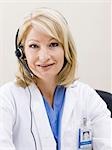 Mature woman talking on headset, studio shot