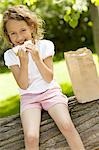 Girl smiling and posing with sandwich