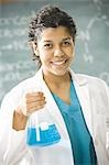 Female science teacher standing in front of a blackboard