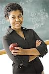 Female teacher standing in front of a blackboard