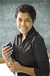 Female teacher standing in front of a blackboard