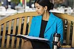 Businesswoman reading from a file folder