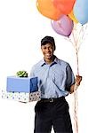 Deliveryman holding gifts and balloons