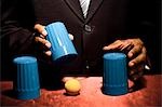 Man doing trick with three cups