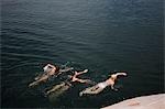 Women jumping into water