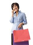 Woman holding shopping bags and talking on cell phone