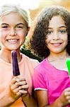 Girls holding popsicles
