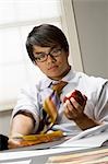 Young man eating apple