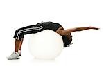 Woman stretching on pilates ball