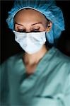 Woman in surgical scrubs looking up