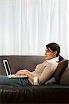 Woman on sofa with laptop