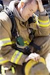 Fire fighter in uniform scratching his head